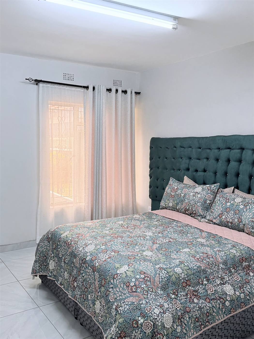 En-suite guest room at Eland Mountain Lodge in Chimanimani with plush headboard and quality bedding